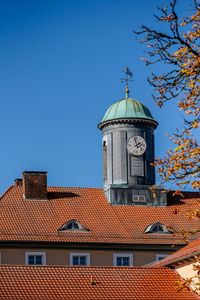 Low angle view of building against clear blue sky