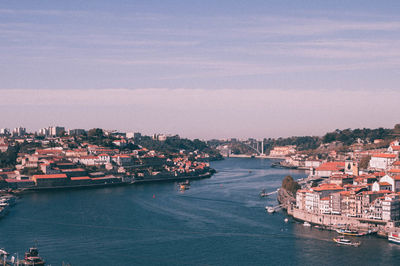 High angle view of cityscape by sea against sky