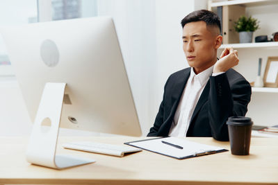 Businesswoman using laptop on table