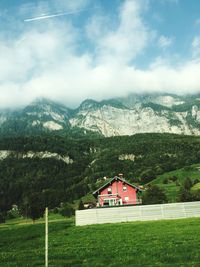 Houses on mountain against sky