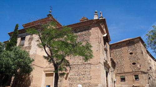 Low angle view of old building against blue sky