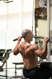 Mature man exercising in gym