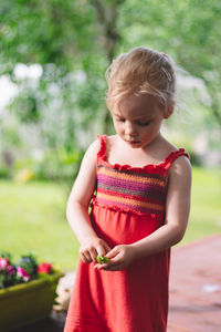 Cute girl looking away while standing outdoors