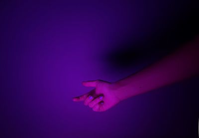 Close-up of woman hand against black background