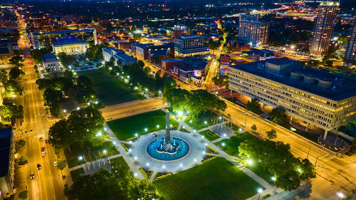 High angle view of illuminated buildings in city at night