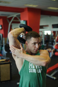 Man lifting dumbbell in gym