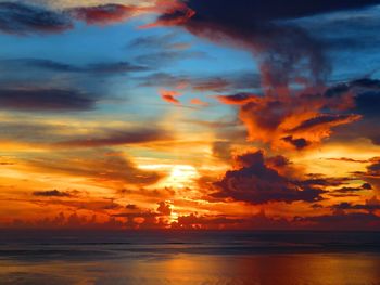 Scenic view of dramatic sky over sea during sunset