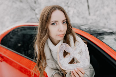 Portrait of beautiful young woman in car