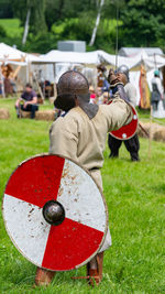 Show fight of medieval knights on a battlefield at the medieval market spectacle