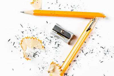 High angle view of colored pencils on white table