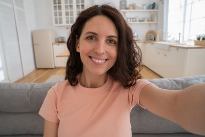 Portrait of smiling woman at home