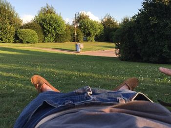 Low section of man relaxing on golf course