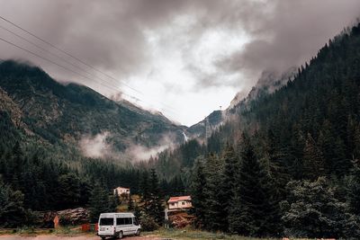 Panoramic shot of land and trees against sky