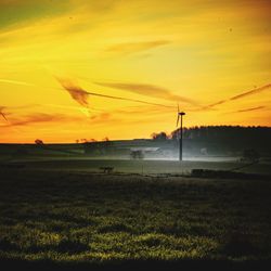 Scenic view of field against sky during sunset