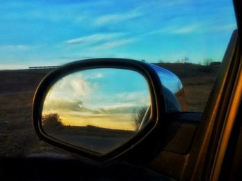 View of side-view mirror of car