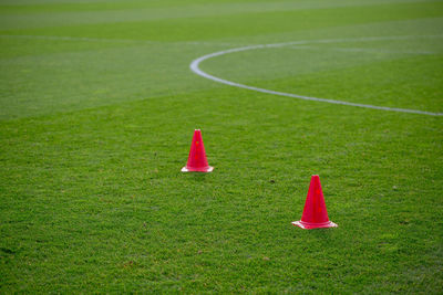 Football practice cones on a green soccer field