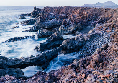 Scenic view of sea against mountain