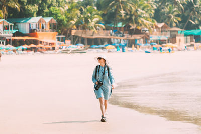 Rear view of woman walking on beach