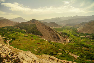 Scenic view of mountains against cloudy sky