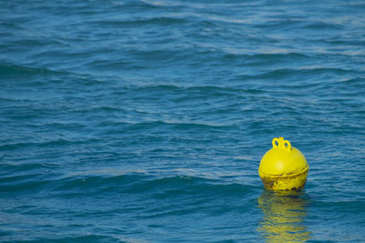 Yellow buoy floating on sea