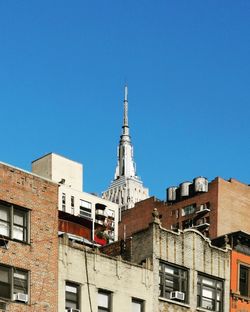 Low angle view of buildings against blue sky