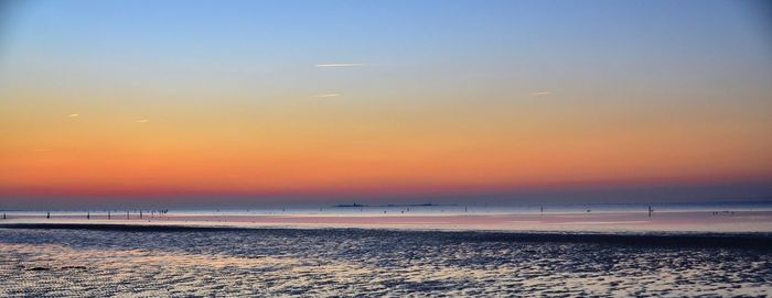 Scenic view of beach against sky during sunset