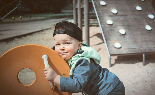 Portrait of boy holding camera