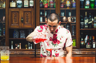 Bartender making drink at bar