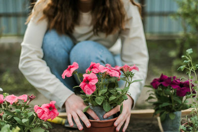 Midsection of woman with bouquet