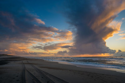 Scenic view of beach against sky during sunset