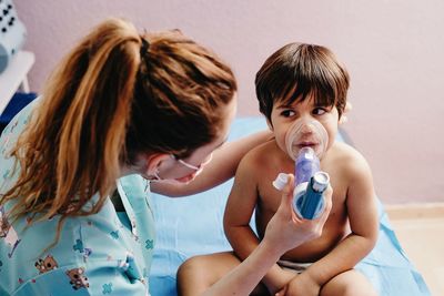 Sick boy getting inhalation treatment in clinic