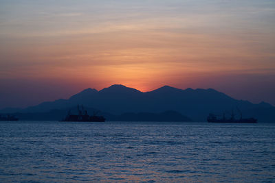 Scenic view of sea against orange sky