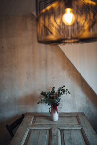 High angle view of vase with bunch of flowers on table