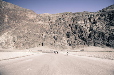 Scenic view of road amidst mountains against sky