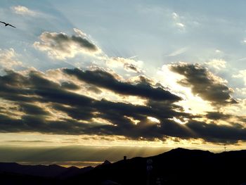 Low angle view of silhouette mountains against sky