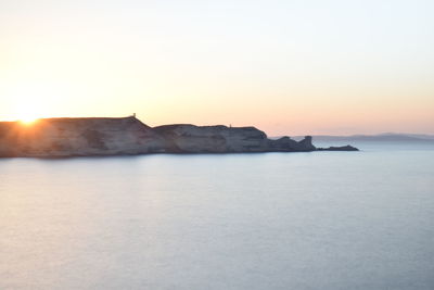 Scenic view of sea against clear sky during sunset