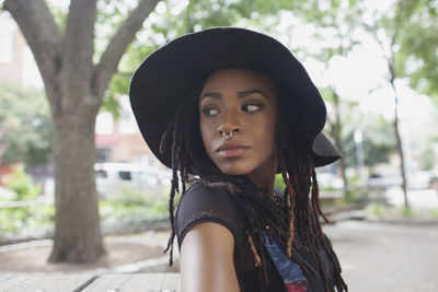 Portrait of beautiful young woman wearing hat