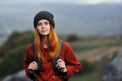 Portrait of beautiful young woman standing outdoors