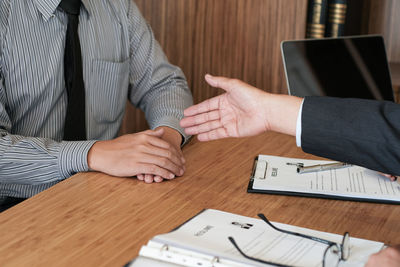 Midsection of man and woman with text on table