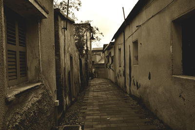 Alley amidst buildings against sky