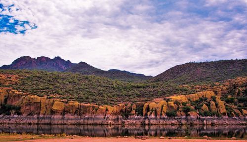 Scenic view of mountains against cloudy sky