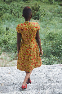 Rear view of woman walking on steps