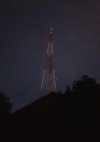 Low angle view of illuminated building against sky at night