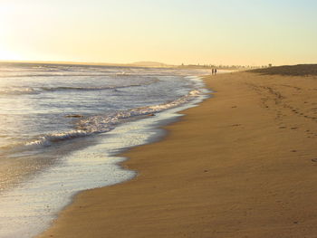 Scenic view of shore and sea against sky