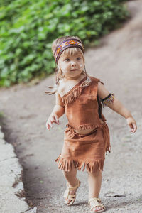 Portrait of young woman standing on road