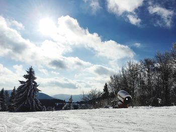 Scenic view of snowcapped field against sky