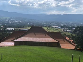 High angle view of houses on field against sky