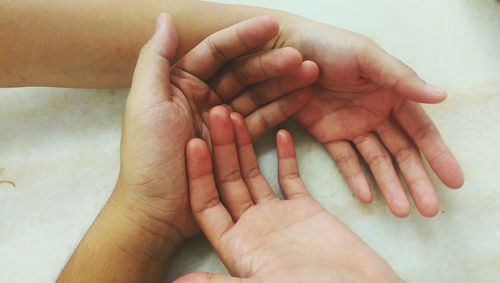 Close-up of hands holding baby hand