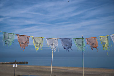 Flags on clothesline against sky