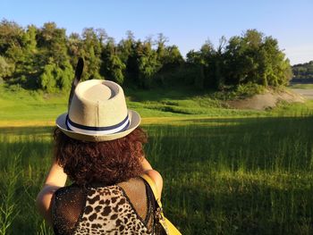 Rear view of woman looking at camera